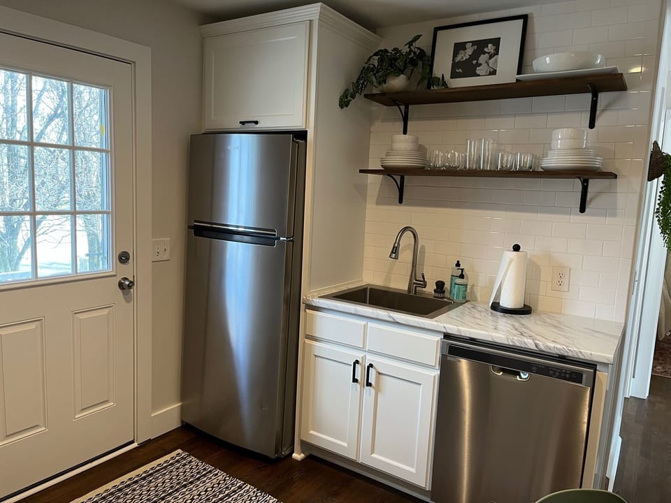 Kitchen with all the essentials, toaster, blender, coffee maker, and dishwasher.