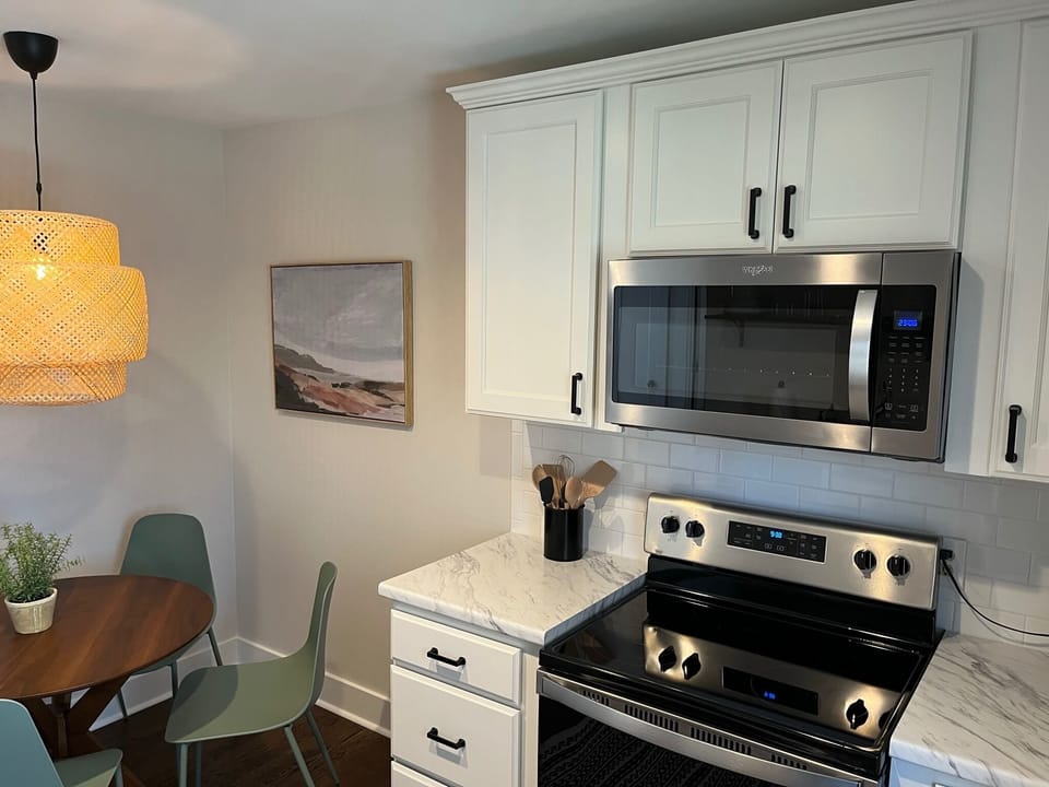 Kitchen with all the essentials, toaster, blender, coffee maker, and dishwasher.