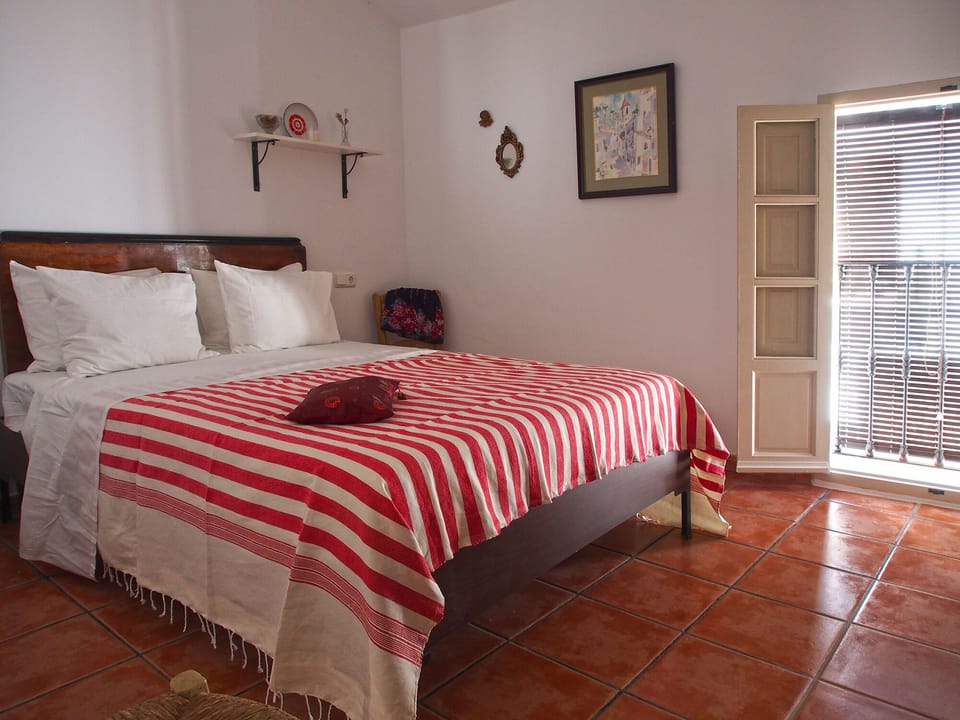 Master bedroom with balcony to the street
