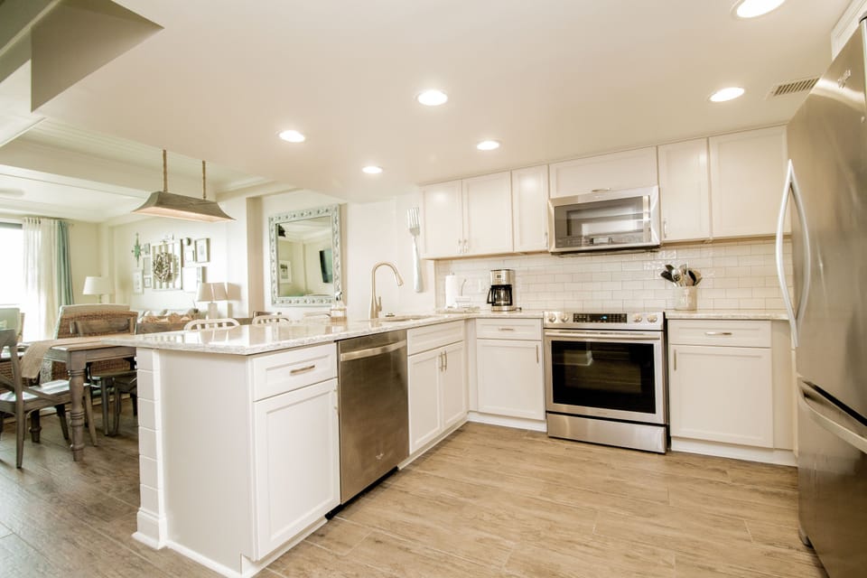 High end cabinets, stainless appliances and oyster shell quartz countertops