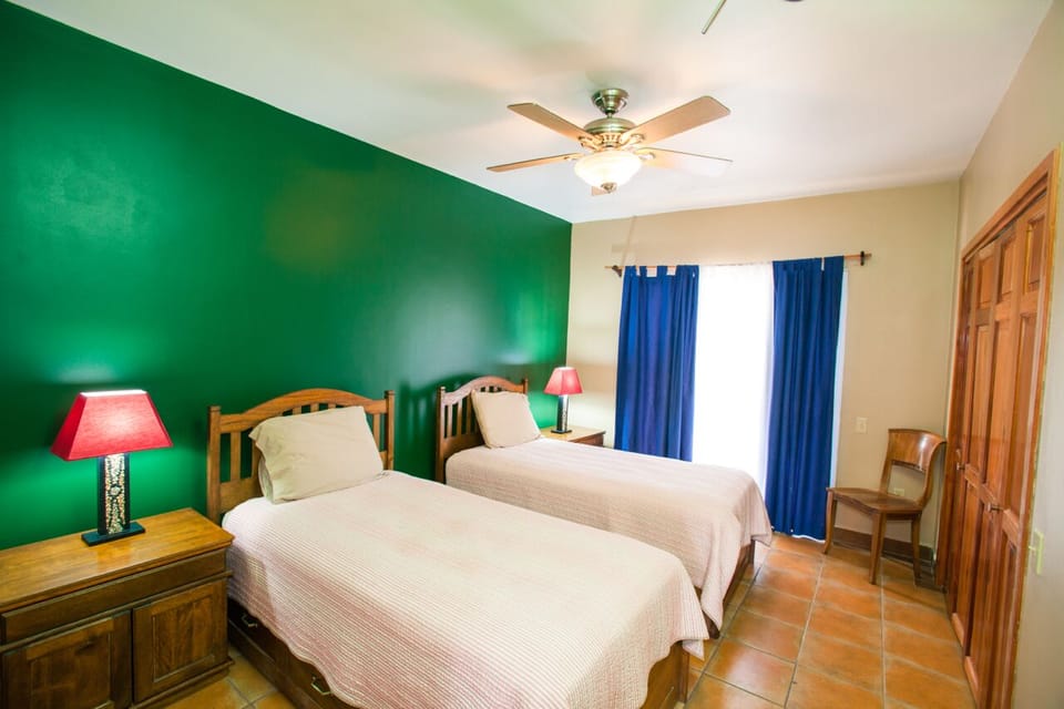 Downstairs bedroom 4 with twin beds and private balcony