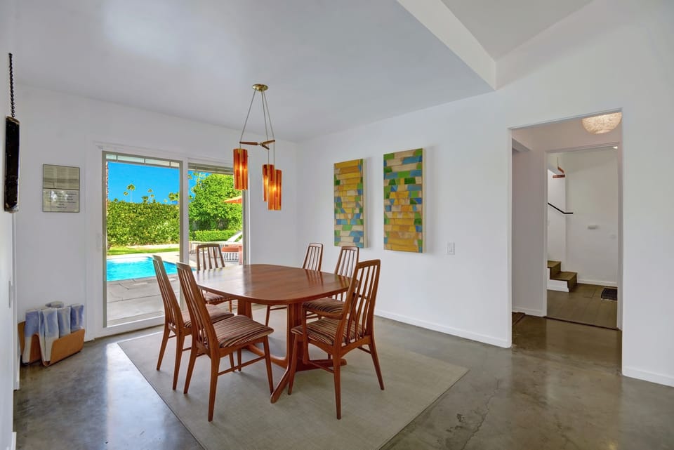 Dining room overlooks the pool with Ice Cube towels rolled in the corner.