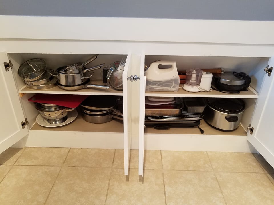 Lots of cookware including crock pot, griddle, mixer, waffle iron, & baking pans