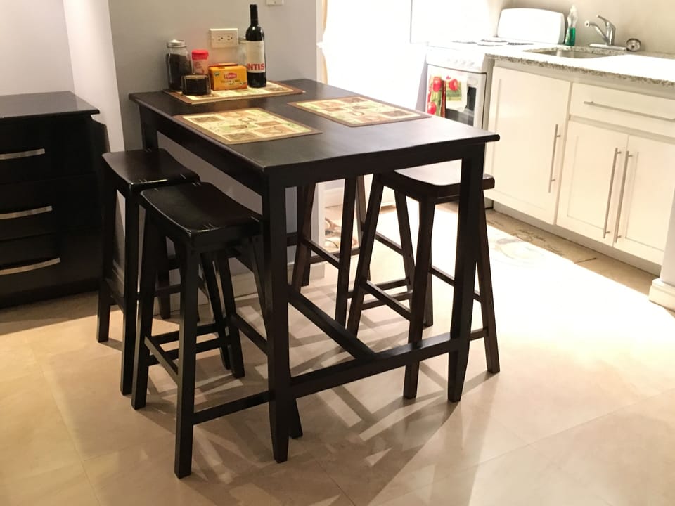 Dining table with four stools. 