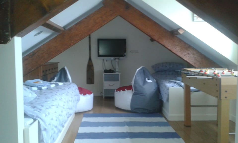 Attic room with 3 cabin beds and table football.