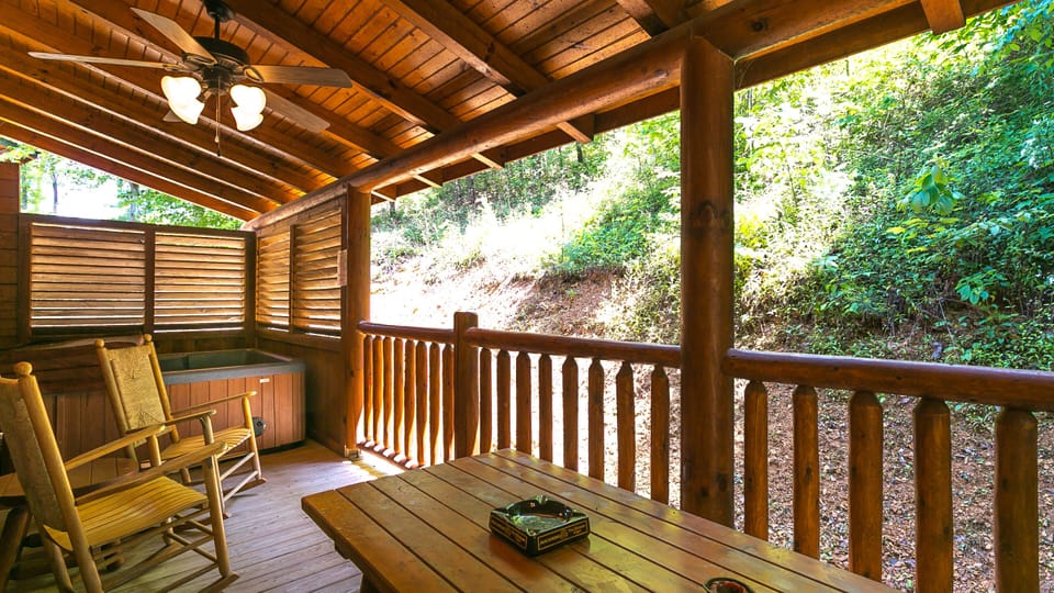 Covered Back Porch with Large Hot Tub, Sauna, Picnic Table, and Rocking Chairs
