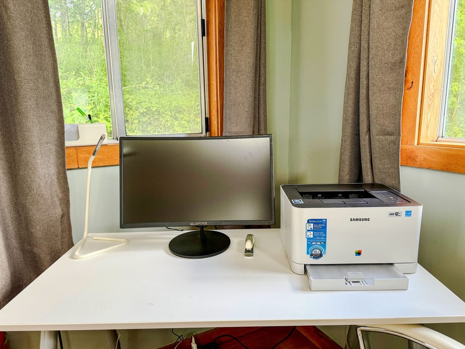 24” monitor, AirPrinter, desk, desk chair, and accessories.