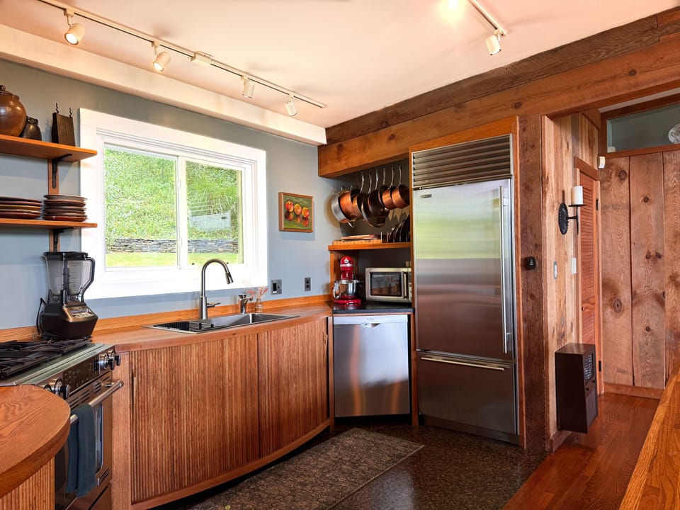 The kitchen features calphalon copper bottom pans, a variety of cutting boards and chef’s knives, SubZero refrigerator, microwave, toaster, and even an on-demand hot water dispenser for coffee, tea and cooking.