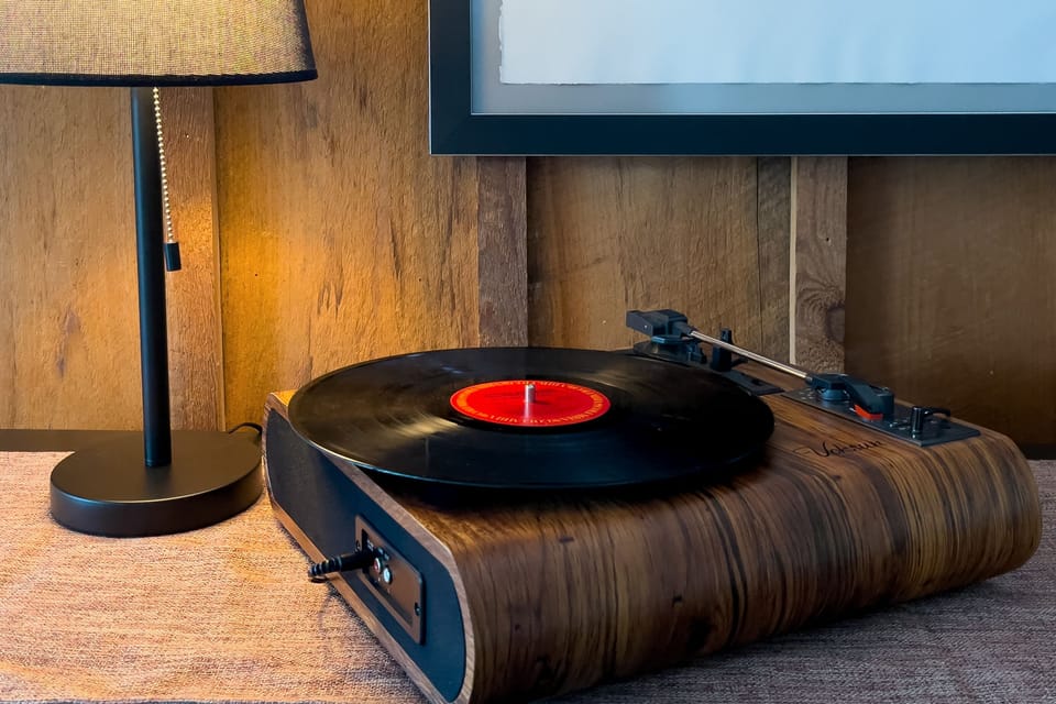 Spin vinyl with a classic turntable and a collection of records covering a range of genres.