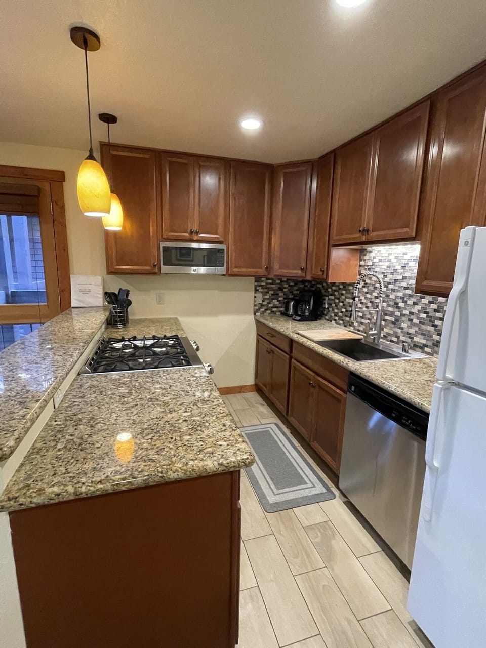 Kitchen is fully equipped with high-end appliances, cookware, and dishes