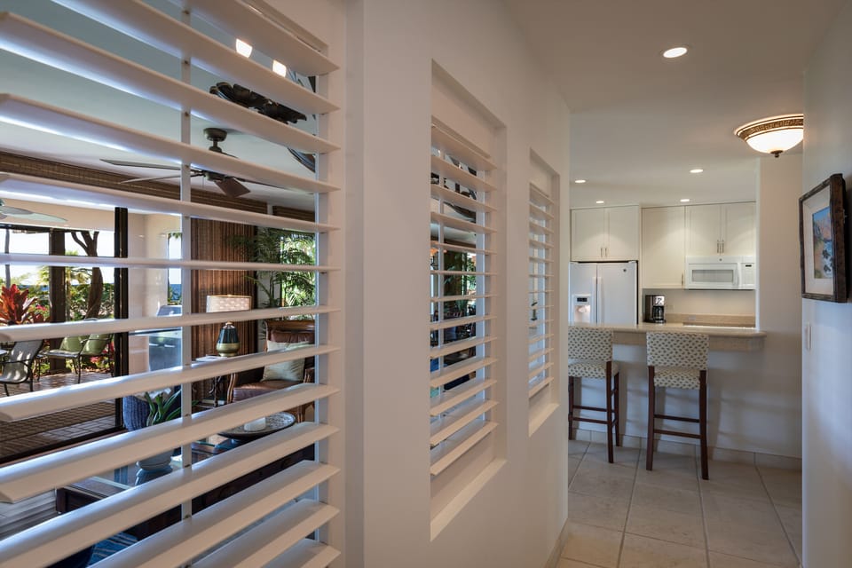 Open feeling hallway with ocean views as you stroll toward the kitchen