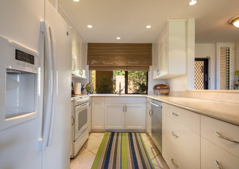 Well-equipped kitchen with smooth top range, quiet dishwasher, & large fridge