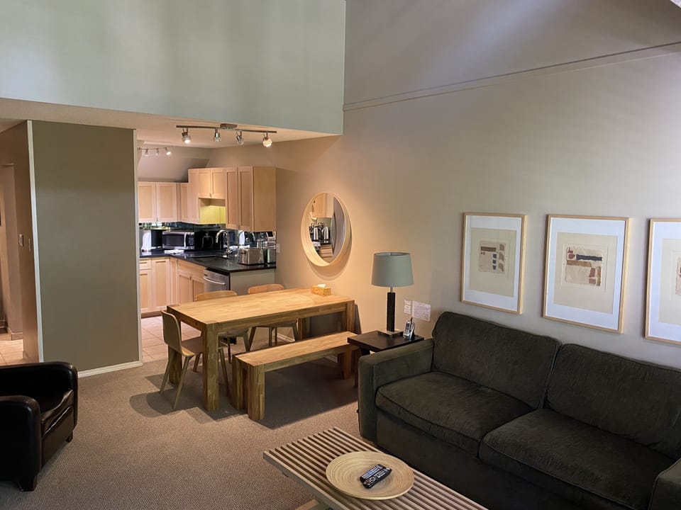 Living/dining area with plenty of seating expandable table & spacious 18'ceiling