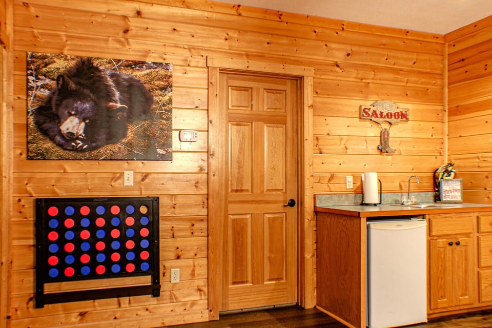 Besides the multitude of games, the game room has a wet bar and mini-fridge.