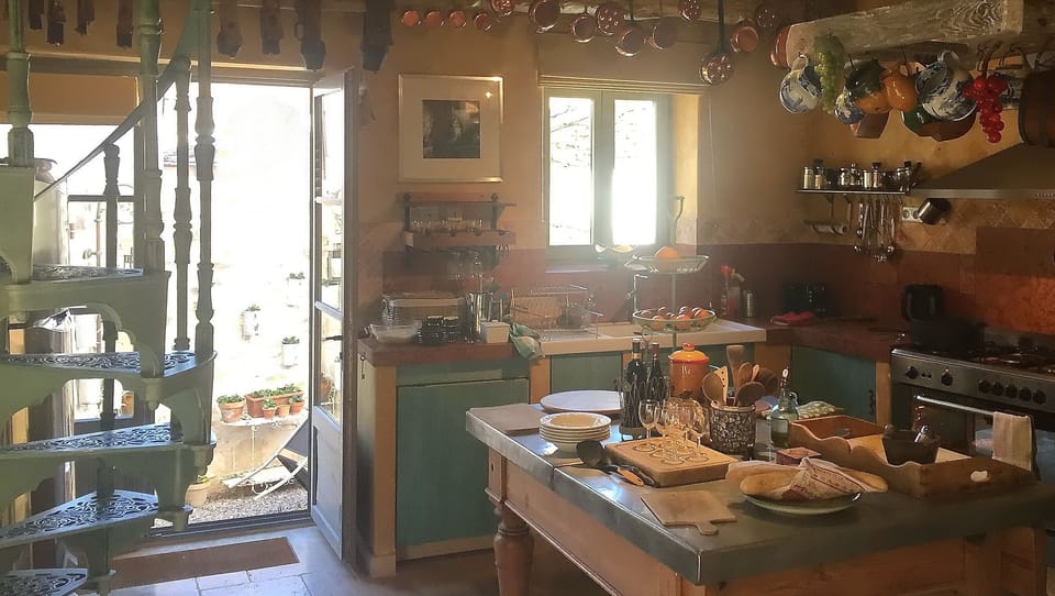 Family Room with kitchen, and large double doors accessing the garden.