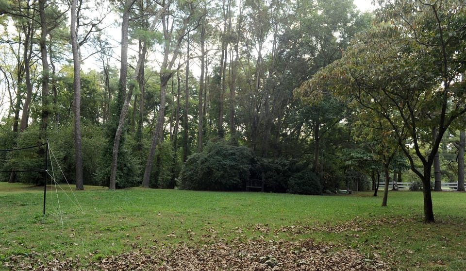 View of back property with badminton net and outdoor games  