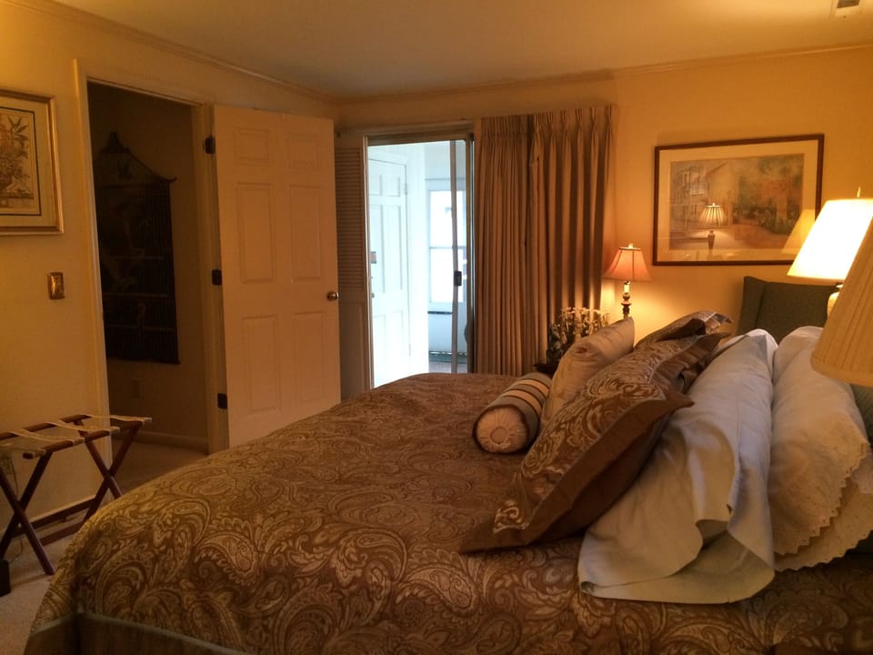 King bed and slider door to screened in porch 