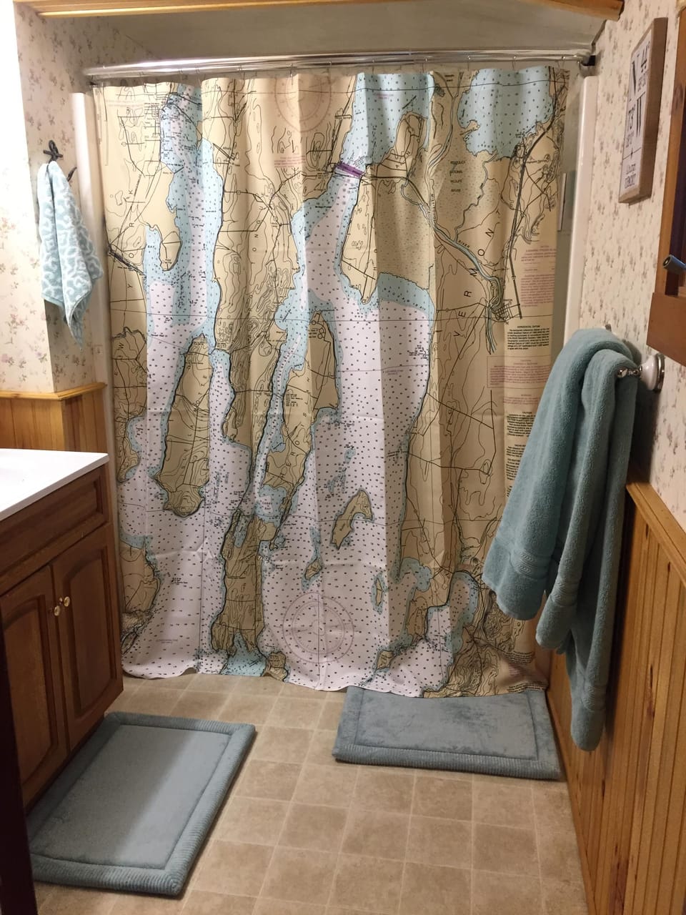 bathroom with fresh soft towels and local map of lake on the shower curtain