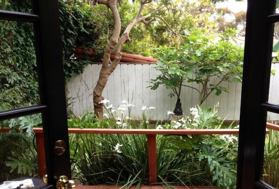 very quiet patio overlooking tropical yard