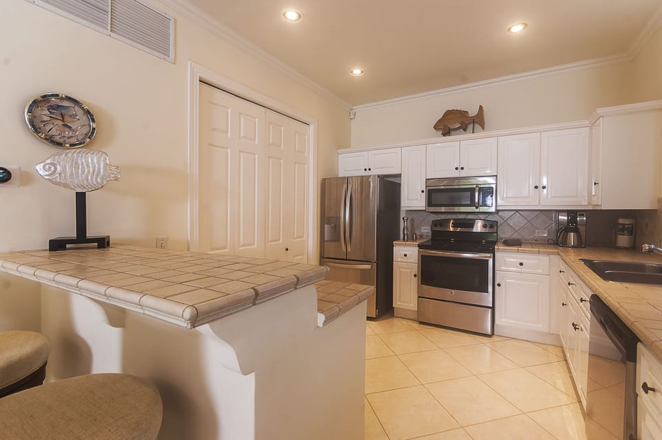 Spacious kitchen with stainless steel appliances, washer and dryer in the closet