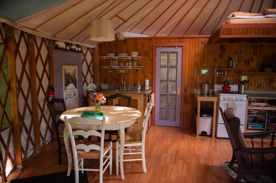 The dining table seats 4. (the full bathroom is behind the purple door)