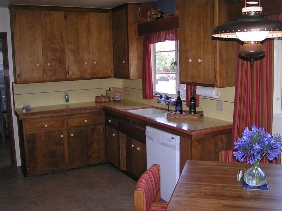 Fully stocked kitchen with all dishes and cooking tools and appliances.