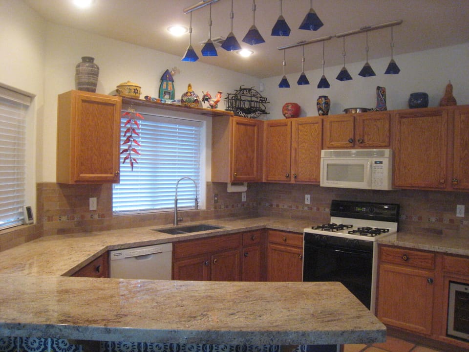 Spacious kitchen with granite counters, breakfast bar, and wine refrigerator