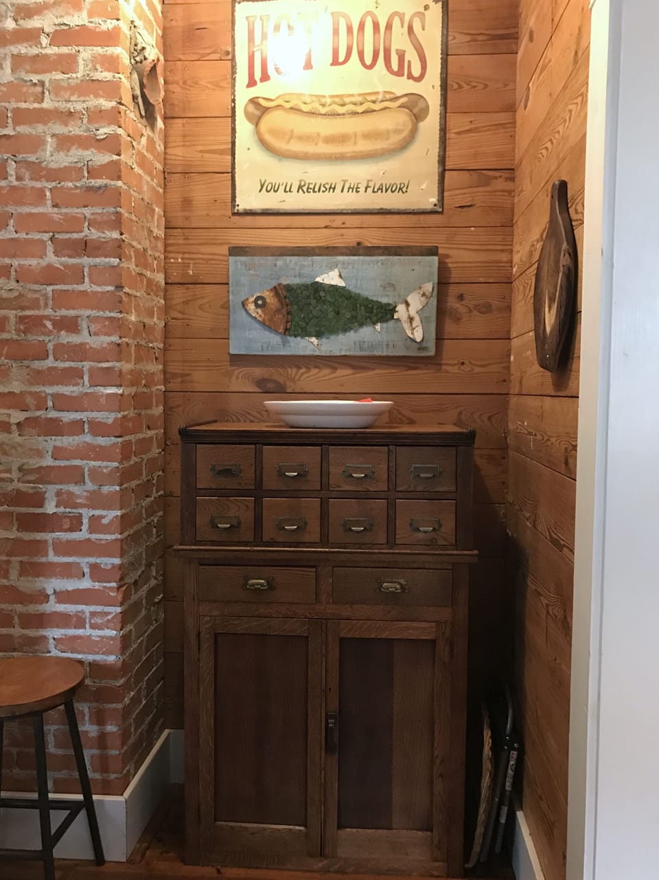 Antique cabinet in kitchen (filled with small appliances, dish towels, etc. 