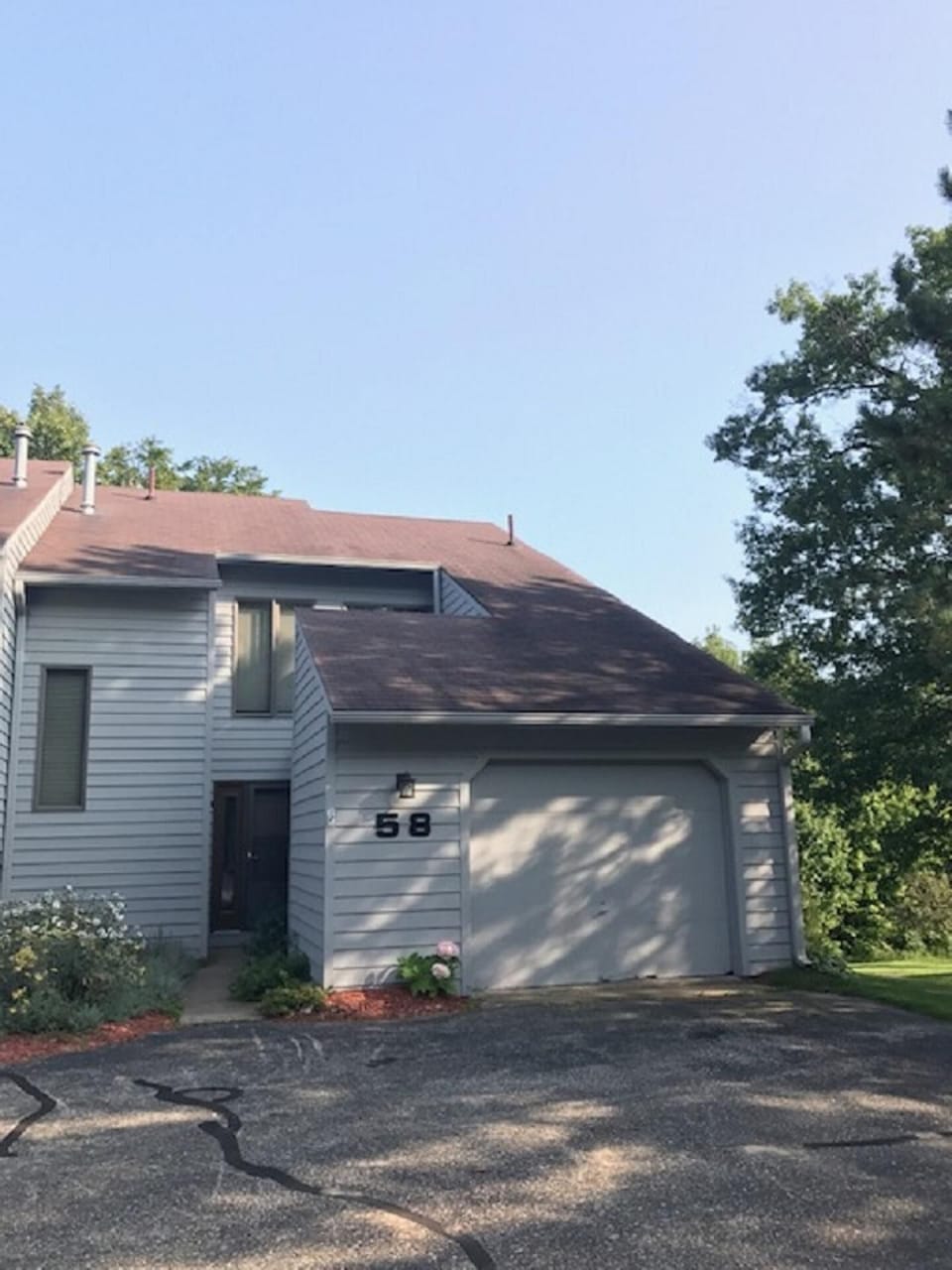 End Unit with ample parking for 2 cars + 1 in garage; overflow parking available
