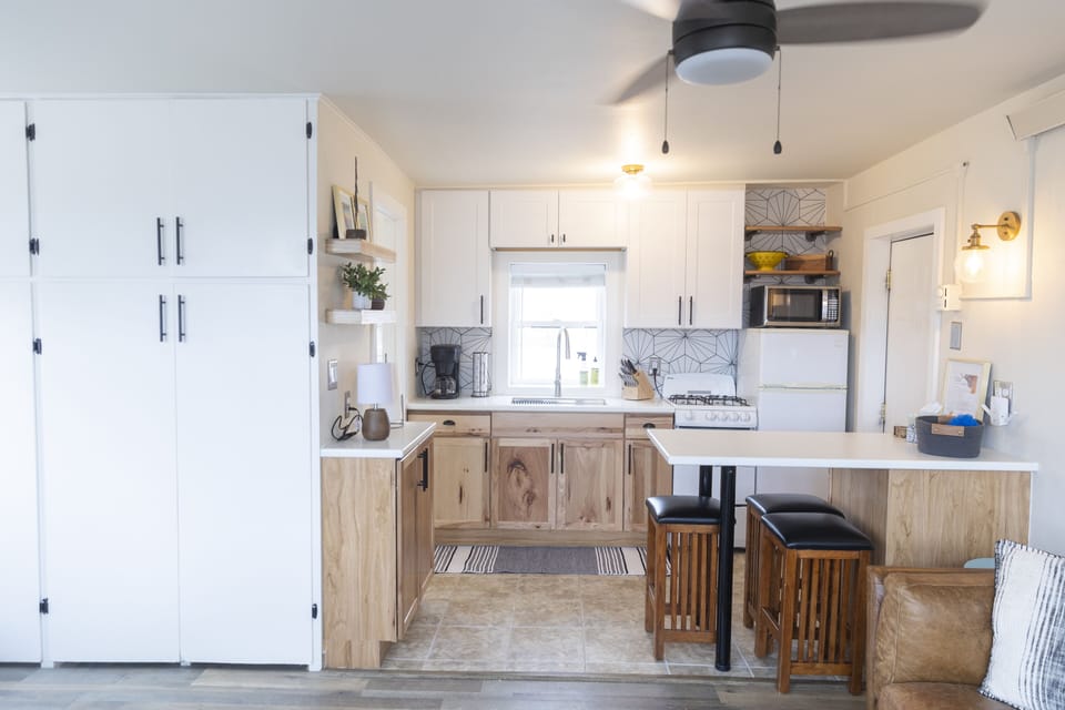 Kitchen includes plates, utensils, pots + pans and linens