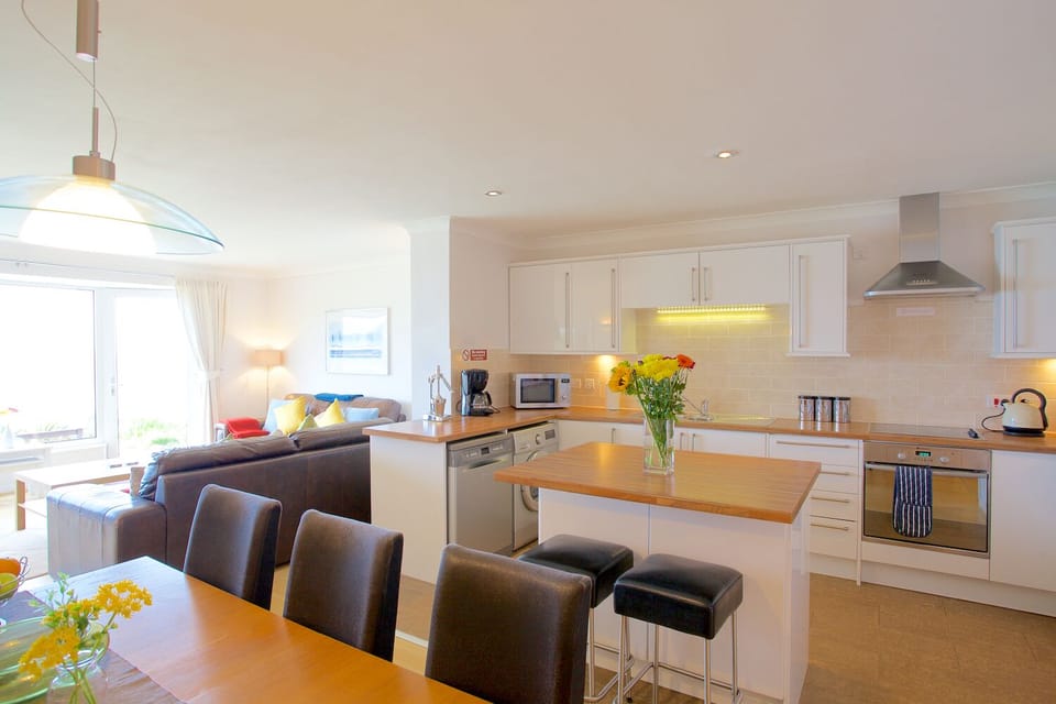 Dining table, breakfast bar and kitchen