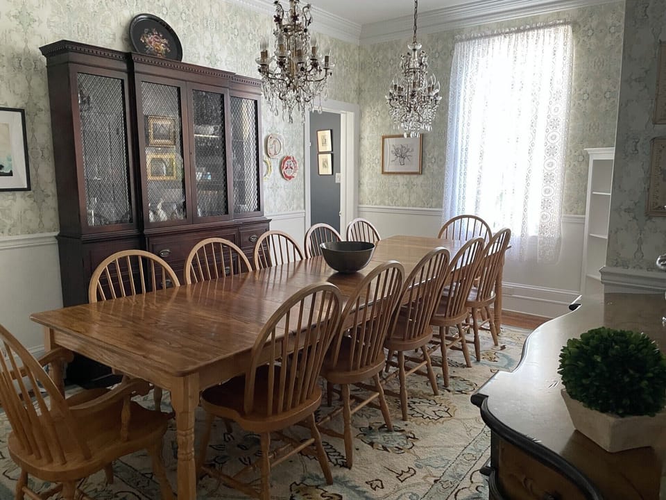 Dining Room with Anthropologie chandeliers, china cabinet, buffet and art