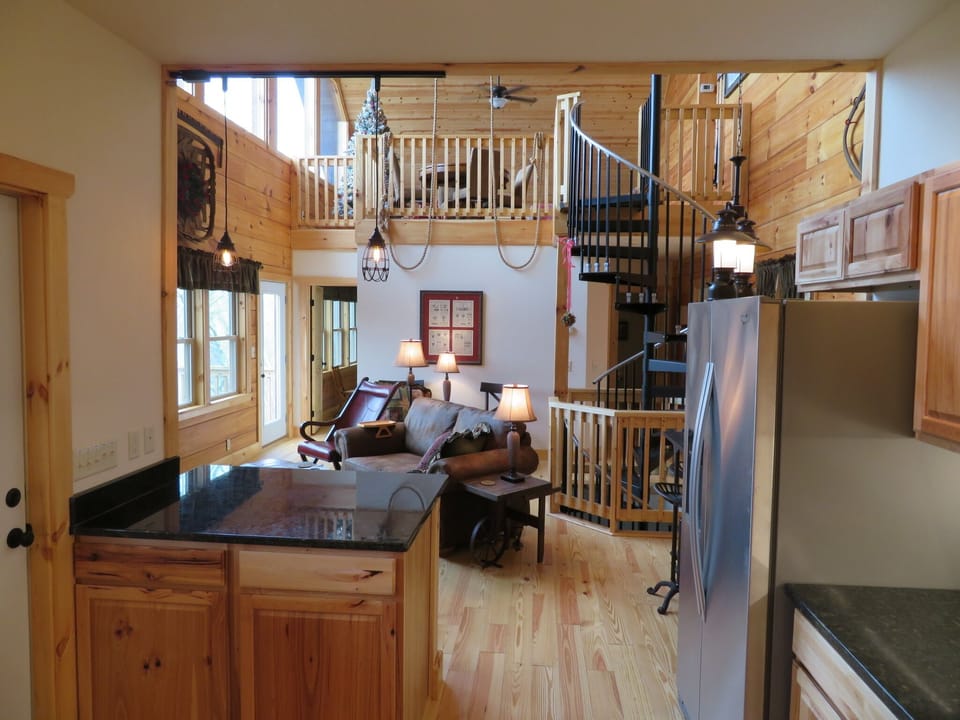 view from kitchen to living room  and spiral stair