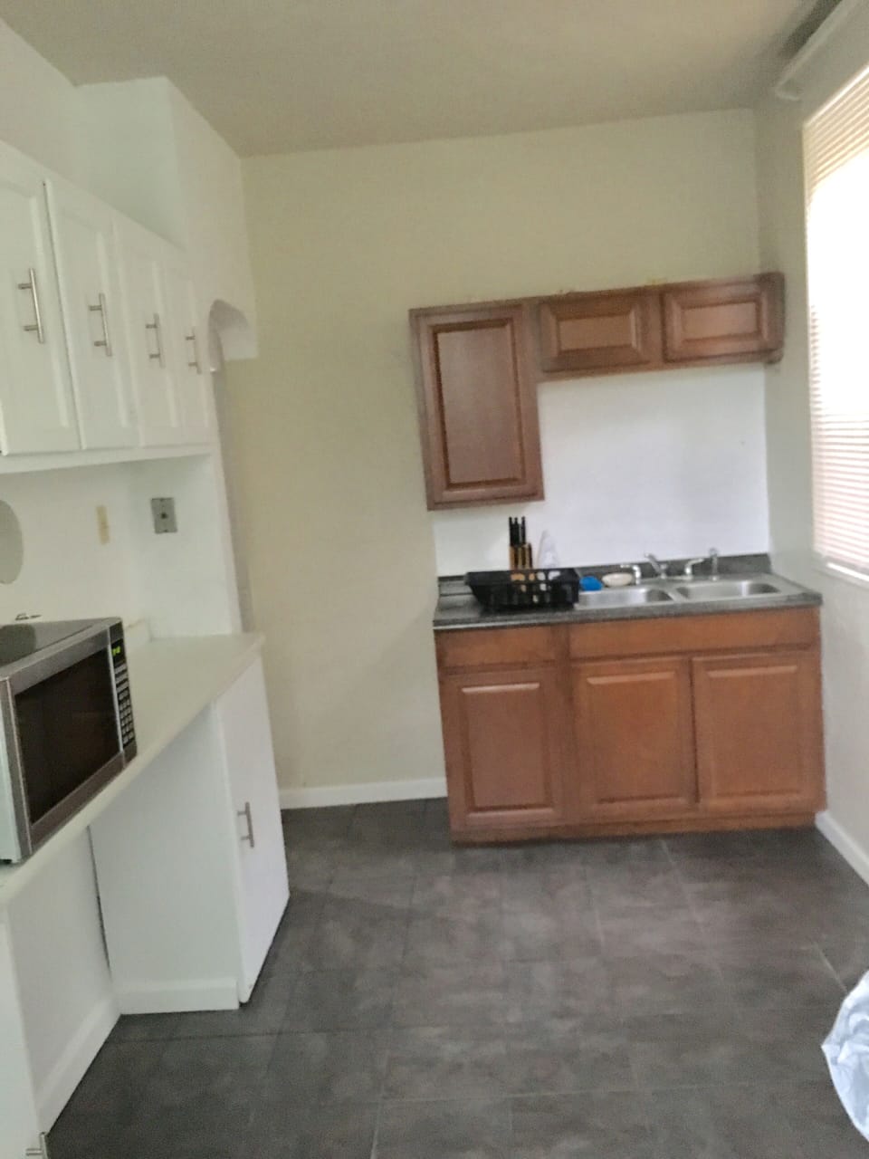 An equipped kitchen awaits you: stove, coffee maker, microwave, and refrigerator