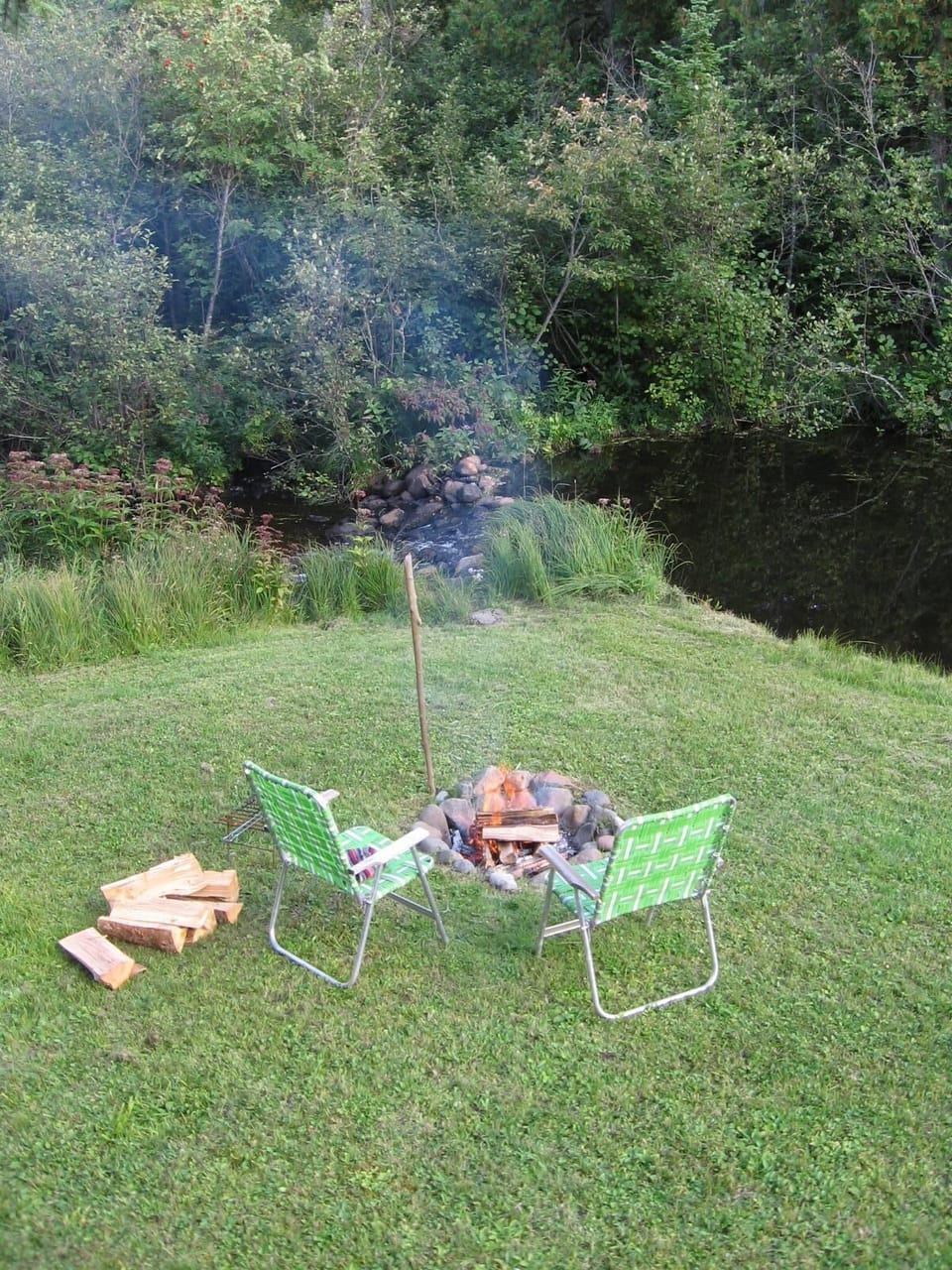 The firepit and our tiny meadow on the river.