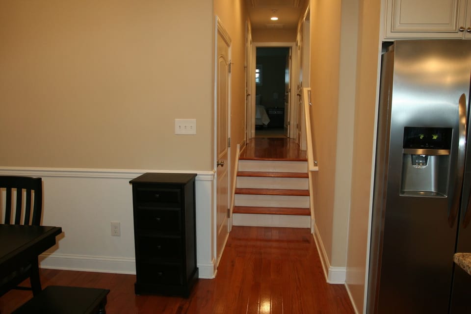 Small stairs gives access to three bedrooms, two full baths and washer/dryer. 