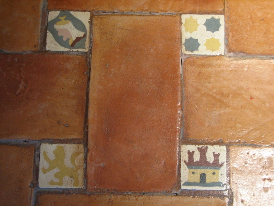 Detalle suelo de barro con piezas decoradas