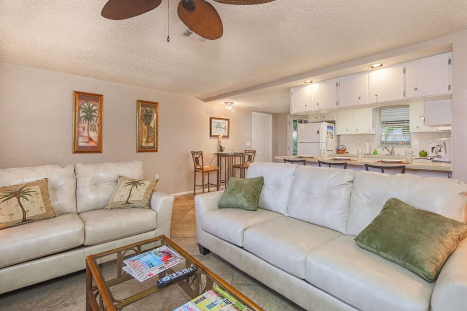 Cozy living room is open to bright and cheery kitchen