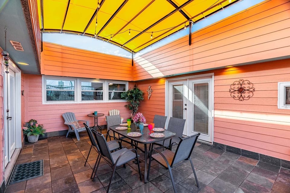 Covered patio, seating for 8, string lights, cozy vibes