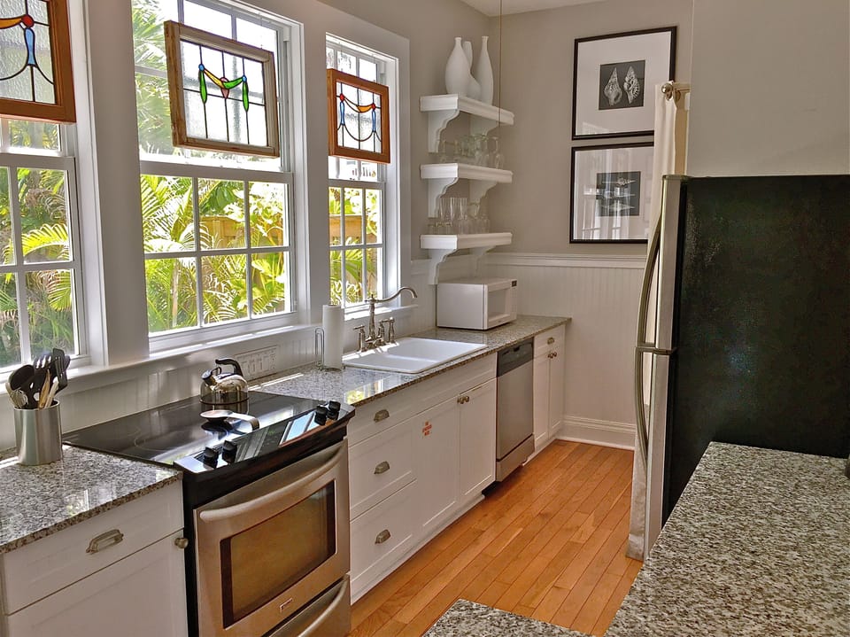 Spacious kitchen. Open cabinets and fully stocked drawers. 