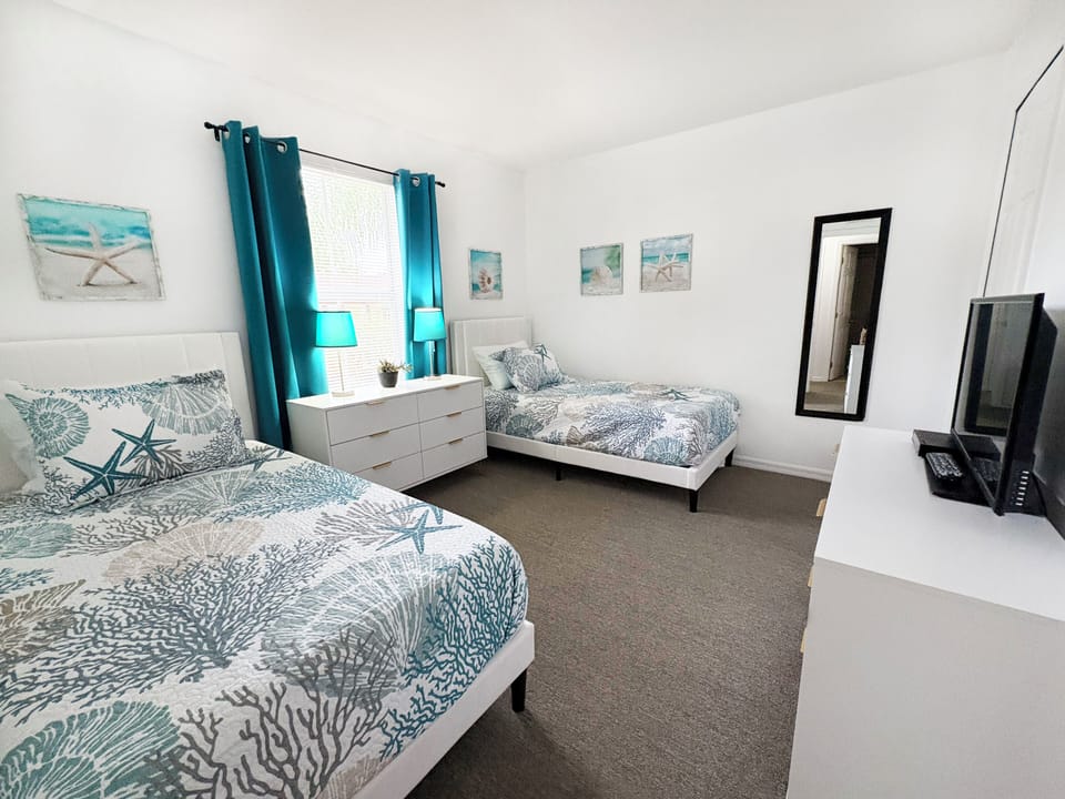 Ocean Room: (Upstairs) 2 twin memory foam beds, 2 dressers, TV, walk-in closet