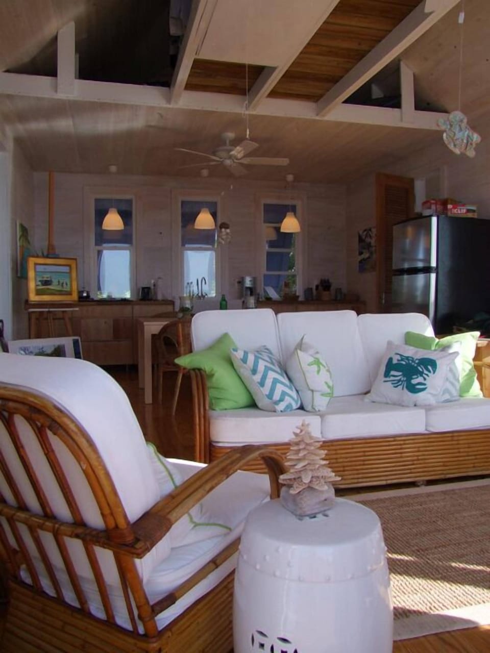 1940's vintage rattan seating. Traditional cypress walls w/ island art decor.