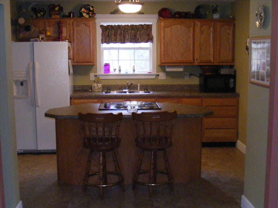 Full kitchen and island with 4 top electric burner, Microwave, Coffee pot, etc.