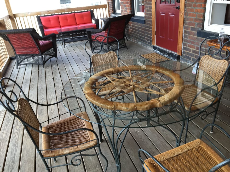 A private deck with large fans to relax while staying cool. This is also your rear entrance, with parking lot below.
