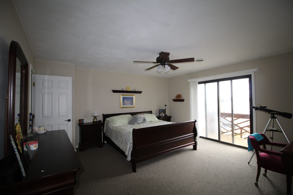 King size bed with private balcony looking over cove.