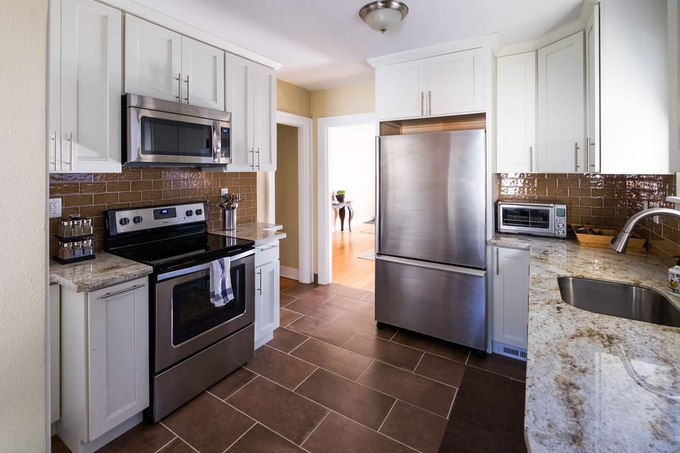 Fully stocked kitchen with stainless steel appliances 