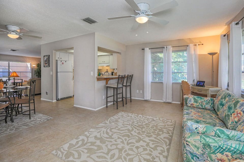 Florida room features a full sized sofa bed for extra guests and a writing desk