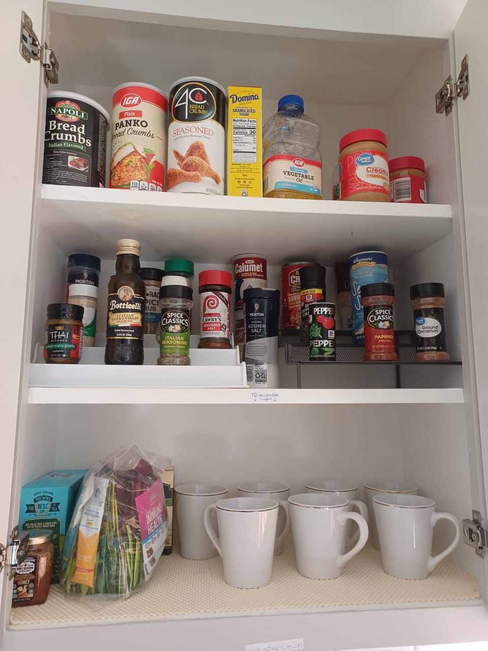 staples, spices, LG variety teas, some coffee cups, more in other cabinet