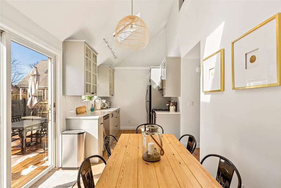 Kitchen open to the dining area and access to the back deck. 