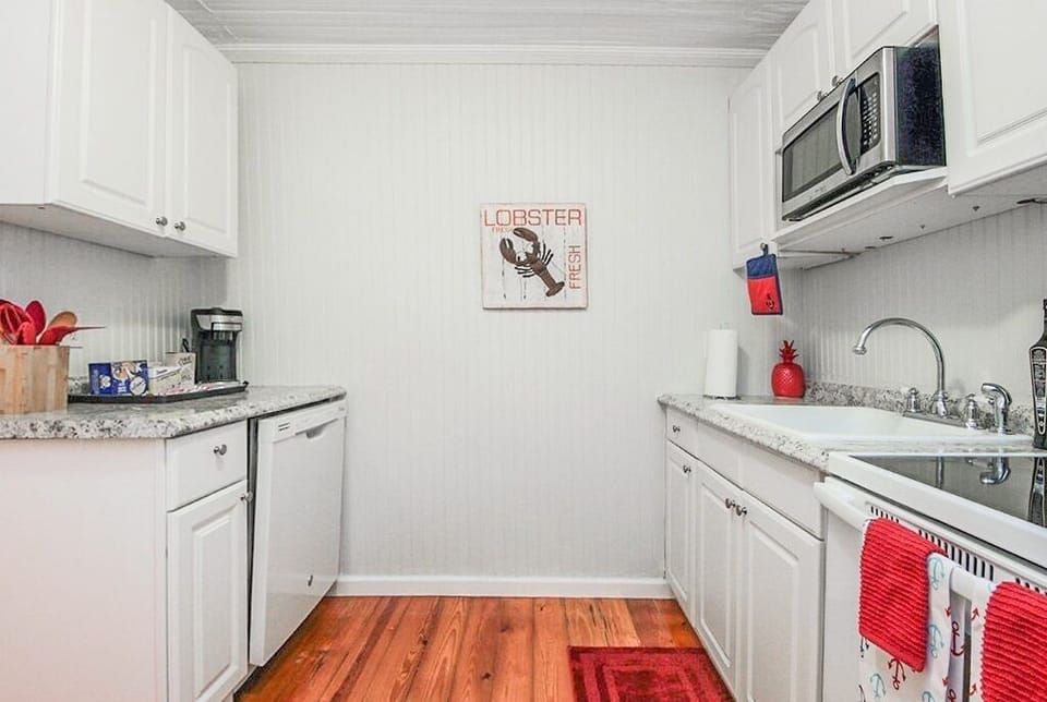 Fully equipped kitchen with stove, microwave, coffee maker and full size fridge.